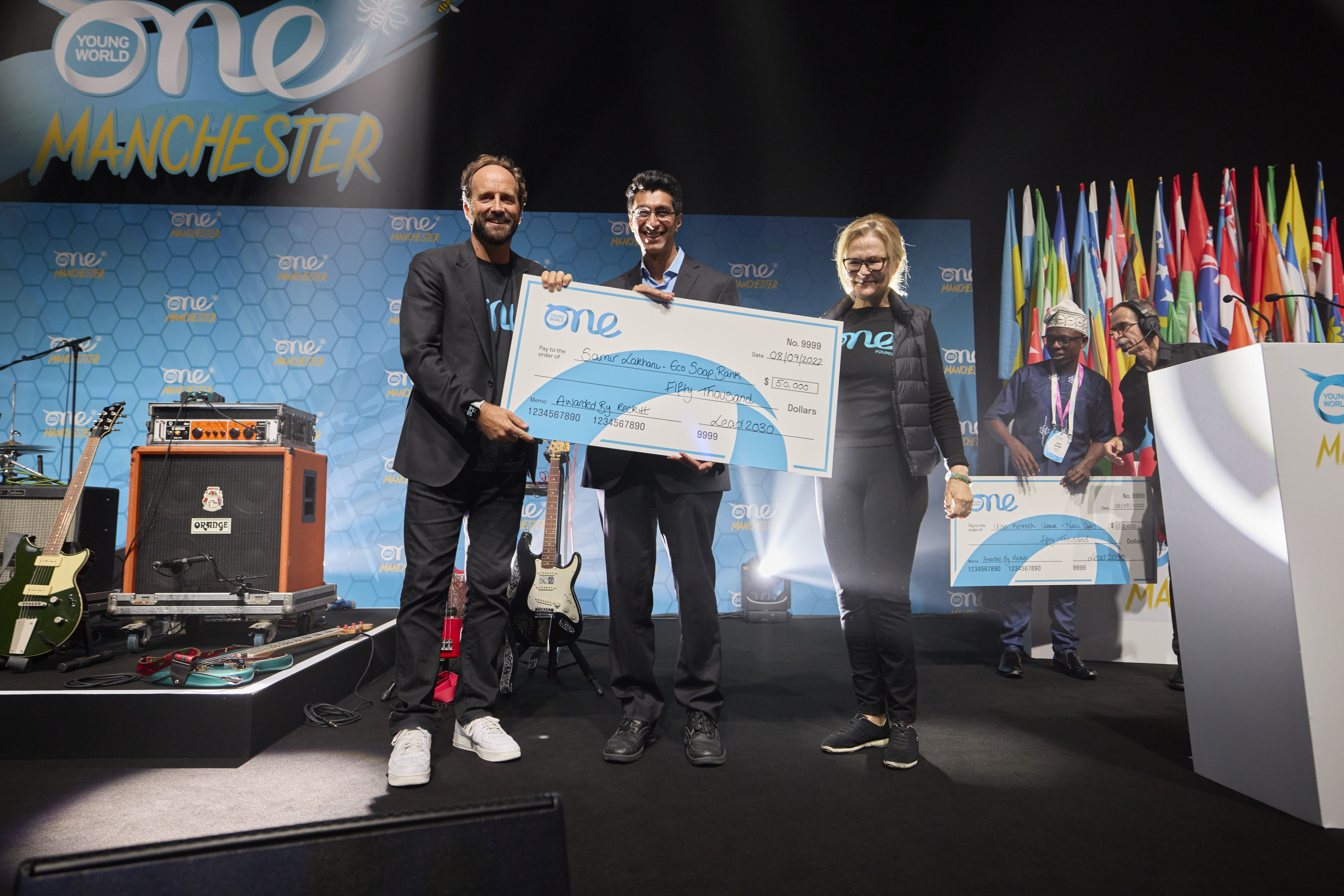Samir Lakhani accepting his Lead 2030 award at the One Young World Summit Manchester, 2022