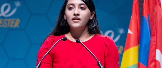 Swara Patel giving a speech at the One Young World Summit Manchester, 2022