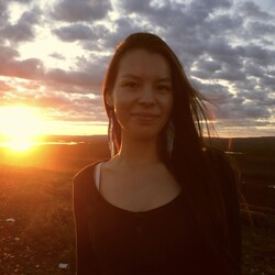 Kananish McKenzie portrait with cloudy sky and sunset / sunrise in the background